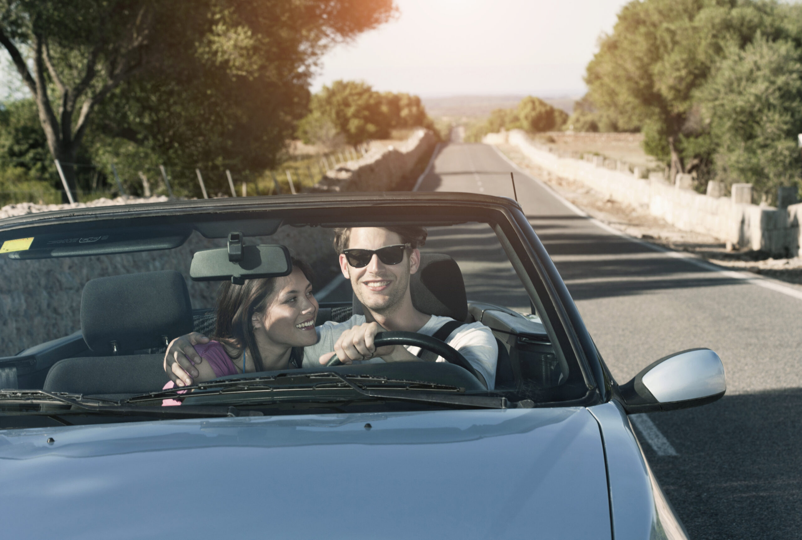 Spain, Majorca, Young couple travelling in cabriolet car